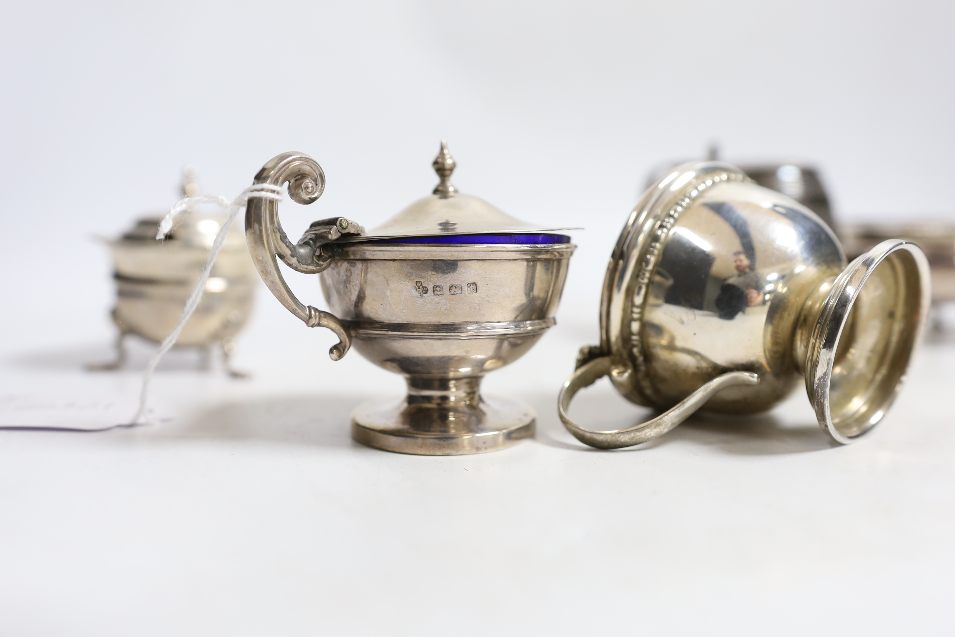 A pair of George III silver bun salts, London, 1767, together with four assorted George V silver mustard pots.